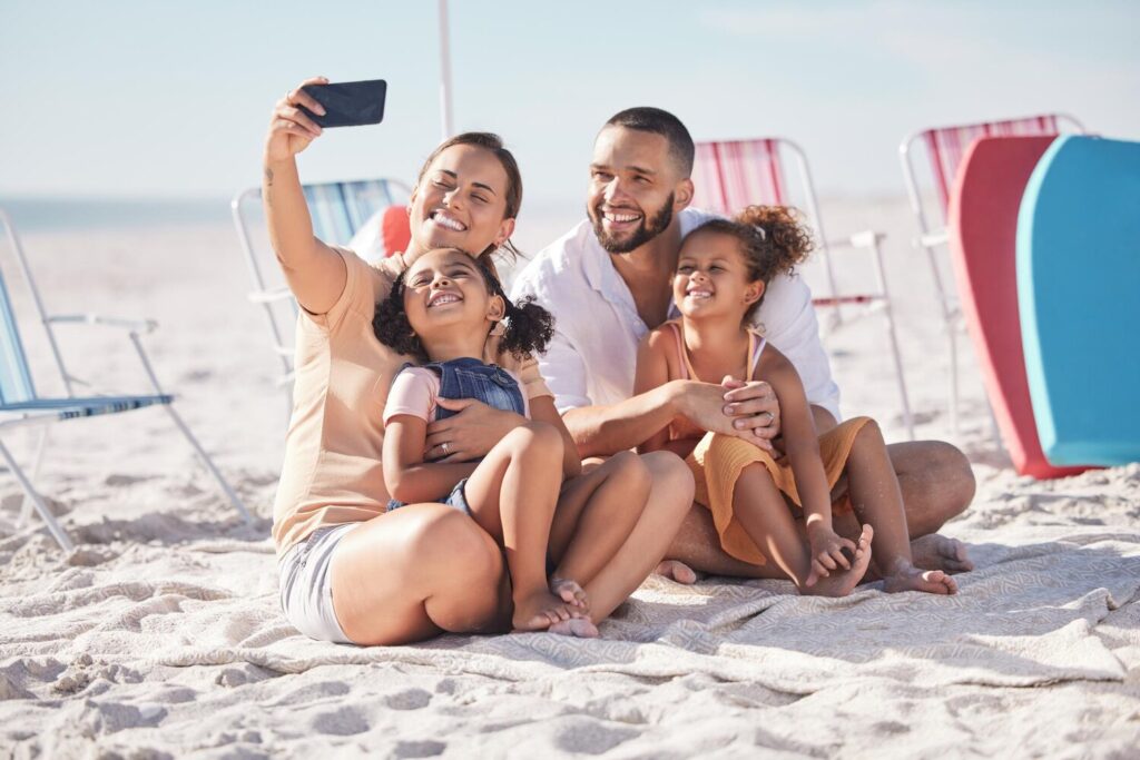 Happy family beach selfie with smile together summer vacation bonding relaxing sand mother father children relax sandy shore holiday break weekend smiling happiness 590464 86834 Happy family beach selfie with smile together summer vacation bonding relaxing sand mother father children relax sandy shore holiday break weekend smiling happiness 590464 86834