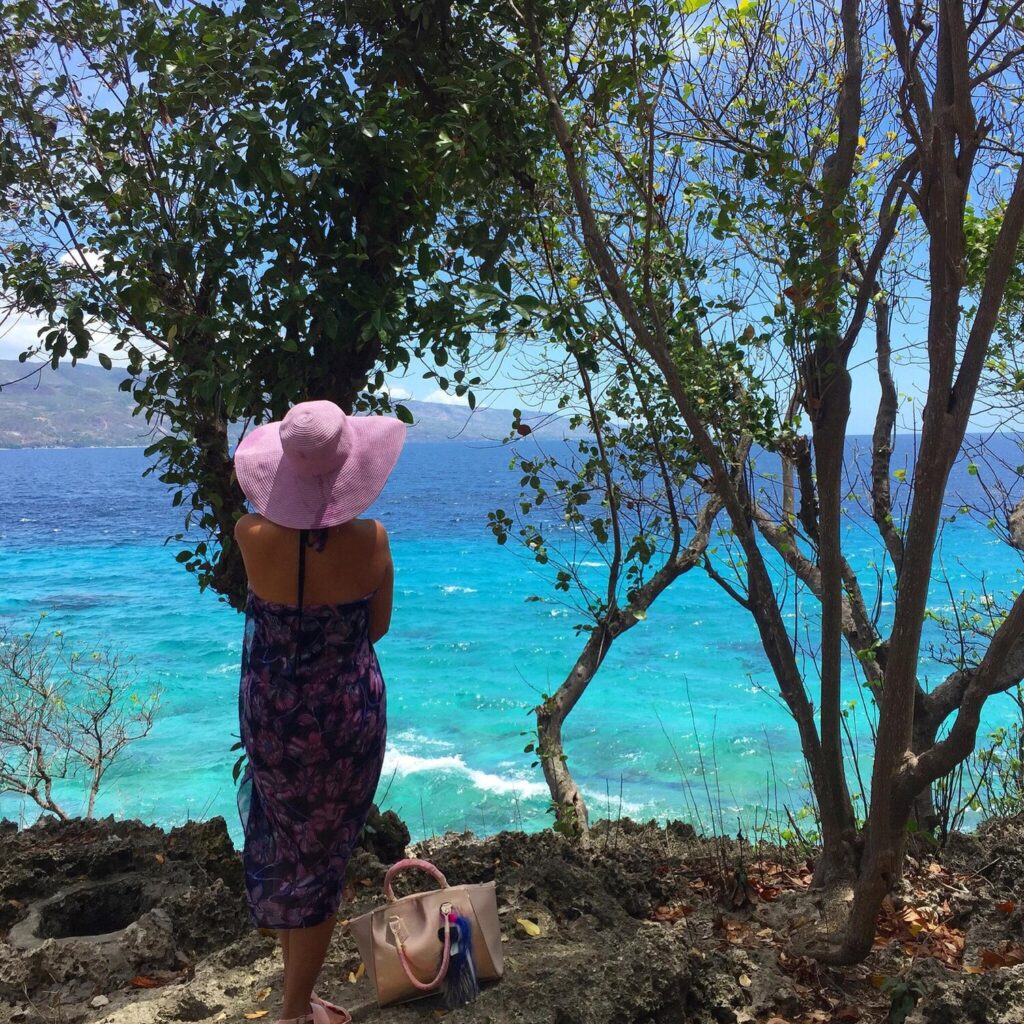 Woman standing beach against trees 1048944 17931096 Woman standing beach against trees 1048944 17931096
